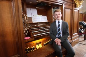 Sam Jones seated at the organ console